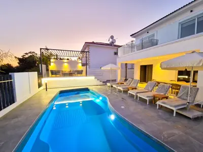 a swimming pool in the backyard of a house at Sunshine Villa Ayia Napa in Ayia Napa