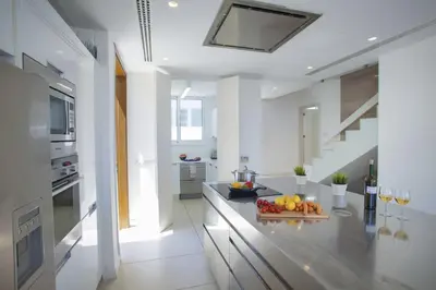 a kitchen with a counter with a bowl of fruit on it at Goodness Villa offers Magnificent Coastal Views in Protaras