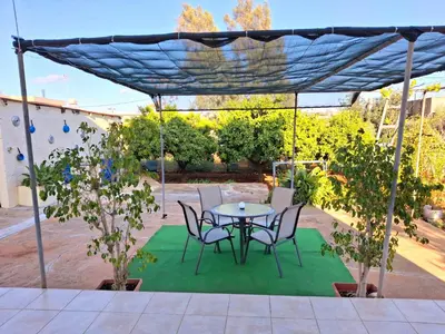 a patio with a table and chairs under a canopy at Grandma's House in Liopetri