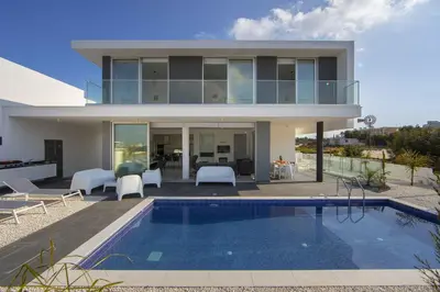 a house with a swimming pool in front of it at Brand New Luxurious Villa With Pool in Protaras