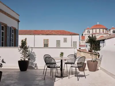 a patio with a table and chairs on a balcony at Amyth of Nicosia in Nicosia