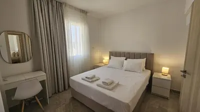 a bedroom with a bed with two towels on it at STAY Local Apartment in Larnaka