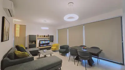 a living room with a couch and a table at STAY Diamond Apartment in Larnaka