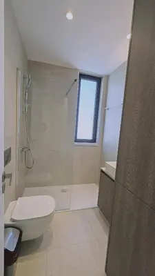 a bathroom with a shower and a toilet and a sink at STAY Diamond Apartment in Larnaka