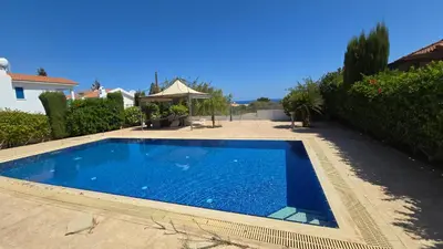 a swimming pool in the yard of a house at Villa Dafni Malama in Paralimni