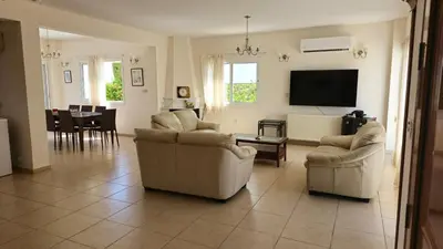a living room with couches and a flat screen tv at Villa Dafni Malama in Paralimni