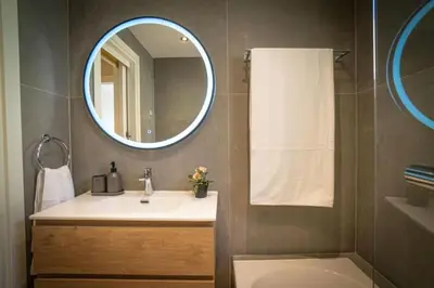 a bathroom with a sink and a mirror at Stylish Newly Renovated Flat, 250 Meters from the Beach, Central Location with Free Parking in Limassol