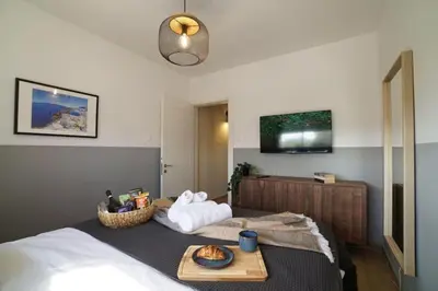 a bedroom with a bed with a tray of food on it at Stylish Newly Renovated Flat, 250 Meters from the Beach, Central Location with Free Parking in Limassol