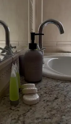 a bathroom counter with a bottle of soap and a sink at Maison Andre in Pano Lefkara