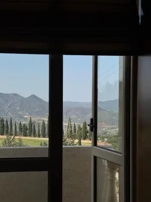a window with a view of a mountain view at Maison Andre in Pano Lefkara