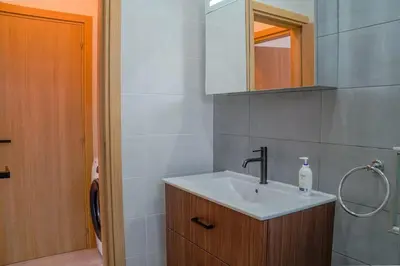 a bathroom with a sink and a mirror at Beautiful One Bedroom Apartment, 186 Meters to Beach, Central Location Next to Cafes & Bars in Limassol