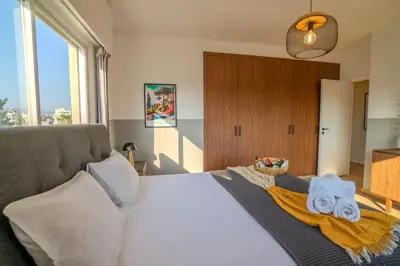 a bedroom with a bed with towels on it at Two Bedroom Apartment, Spacious & Newly Renovated, Three Minutes from the Beach in Limassol