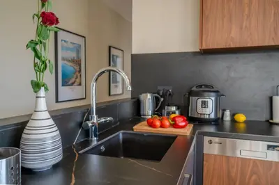 a kitchen with a sink and a counter top at Two Bedroom Apartment, Spacious & Newly Renovated, Three Minutes from the Beach in Limassol