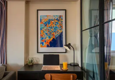 a desk with a laptop and a lamp in a room at Two Bedroom Apartment, Spacious & Newly Renovated, Three Minutes from the Beach in Limassol