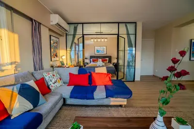 a living room with a couch and a bed at Two Bedroom Apartment, Spacious & Newly Renovated, Three Minutes from the Beach in Limassol