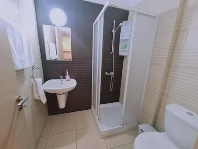 a bathroom with a shower and a sink and a toilet at Coralli Privileges Apt in Protaras