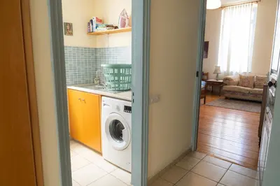 a laundry room with a washing machine in a kitchen at ANANKE Home in Nicosia