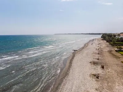 a beach with a group of people on it at Yialos Village by Cybarco in Larnaka
