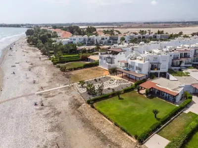 an aerial view of a beach with white buildings at Yialos Village by Cybarco in Larnaka