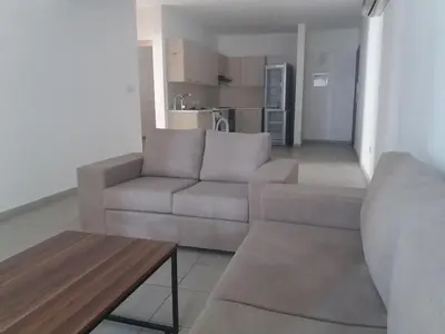 a living room with a couch and a table at alfaro57 in Nicosia