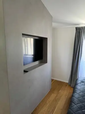 a living room with a flat screen tv on a wall at Larnaca Centre Villa in Larnaka