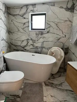 a bathroom with a tub and a toilet and a sink at Larnaca Centre Villa in Larnaka