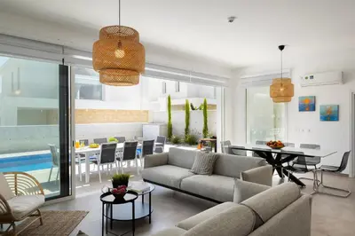 a living room with a couch and a dining room at Protaras Bay View Villa 11 in Protaras