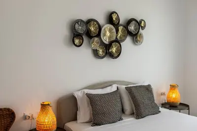 a bedroom with a bed with plates on the wall at Protaras Bay View Villa 11 in Protaras