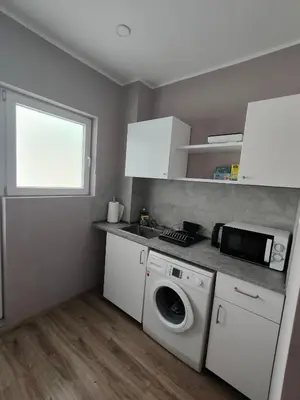 a kitchen with a washing machine and a microwave at Studio in the centre of Nicosia 2 in Nicosia