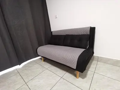a bed sitting in a room next to a wall at Freminore Eden Studio in Ayia Napa