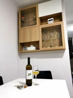 a bottle of wine and a glass on a table at Freminore Eden Studio in Ayia Napa
