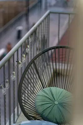 a green umbrella sitting on a chair on a balcony at Heart Of Nicosia - The Gem in Nicosia