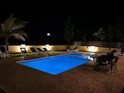 a swimming pool at night with chairs around it at Palm Villa 3 bedrooms - Sleeps 6 in Ayia Napa