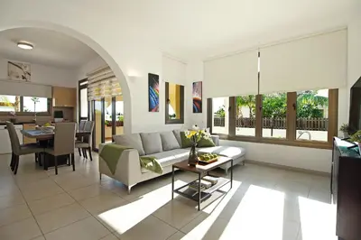 a living room with a couch and a table at Villa Merry in Ayia Napa