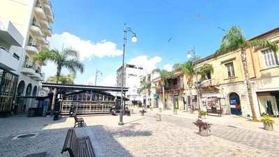 a cobblestone street in a city with buildings at Lovely 1BR in Old Town - City Center & 4min to Beach in Scala