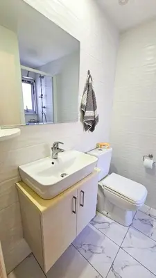 a bathroom with a sink and a toilet at Seaside Comfort Residence in Larnaka