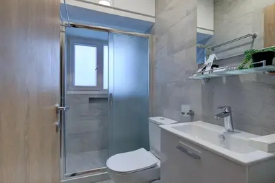 a bathroom with a toilet and a sink and a shower at 75 Prokymea- Steps from the Sea, Downtown, Balcony in Limassol
