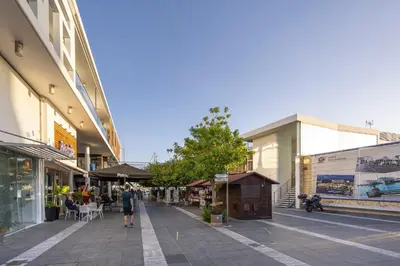 a street with buildings and people walking on the sidewalk at 75 Prokymea- Steps from the Sea, Downtown, Balcony in Limassol