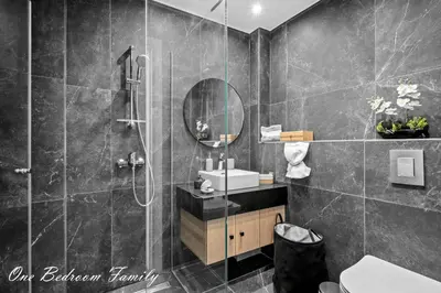 a bathroom with a shower and a sink and a mirror at Lazuli Hermes Apartments in Larnaka