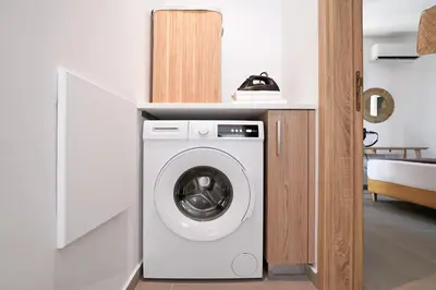a white washer and dryer in a room at Villa Clio - 3bed All En-suite with Private Pool in Paralimni