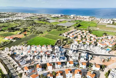 an aerial view of a town with white buildings and the ocean at Villa Clio - 3bed All En-suite with Private Pool in Paralimni