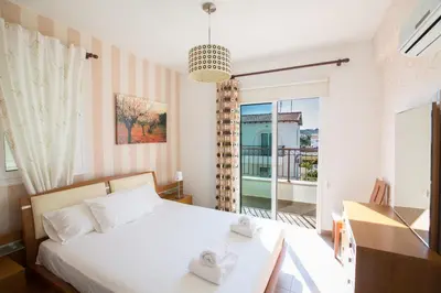 a bedroom with a bed with two towels on it at Katerina Luxury Villas in Protaras