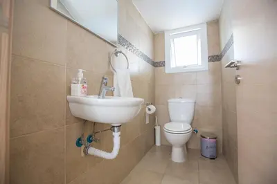 a bathroom with a sink and a toilet at Katerina Luxury Villas in Protaras