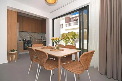 a kitchen and dining room with a table and chairs at Villa Flora - 3Bed all En-suite with Private Pool in Paralimni