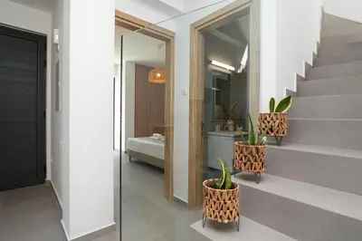a bathroom with two potted plants and a staircase at Villa Flora - 3Bed all En-suite with Private Pool in Paralimni