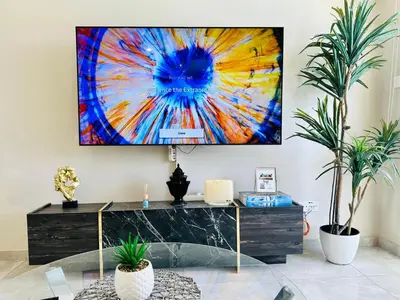 a living room with a tv hanging on the wall at Luxury Villa LAPIS LAZULI in Meneou