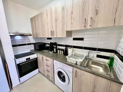a kitchen with a sink and a washing machine at Cristiana Sea Breeze, Sleeps 3, Free Wifi in Limassol
