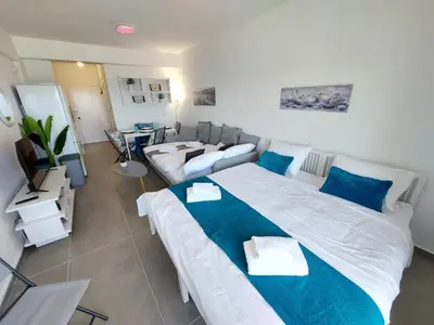 a large bedroom with a large bed and a couch at JUST on the beach Makenzy Studio in Scala