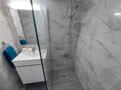 a bathroom with a shower and a sink at JUST on the beach Makenzy Studio in Scala