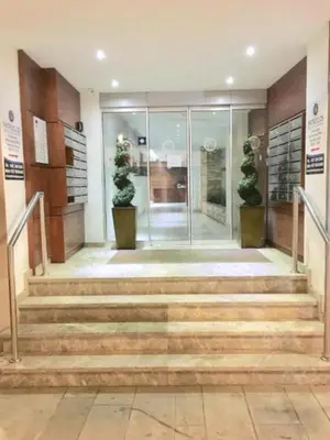 a lobby with stairs and potted plants at Ithaki Phinikoudes Apartment No. 102 in Larnaka